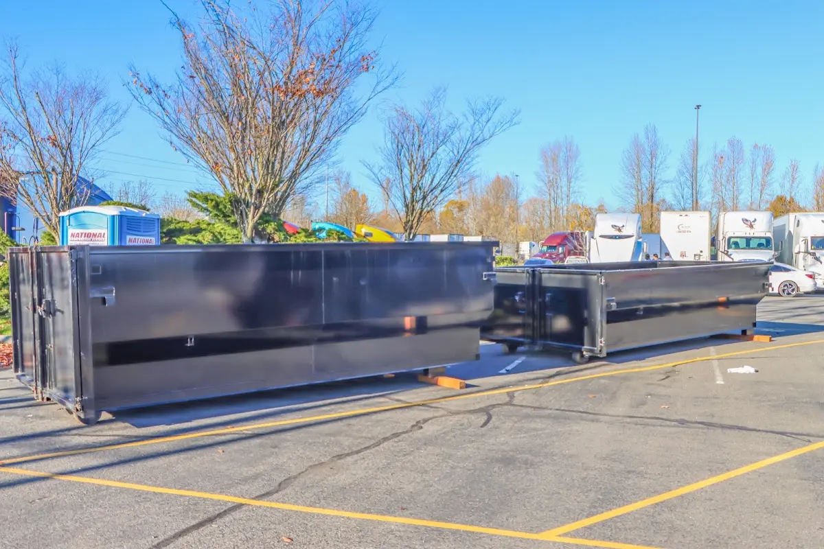 Professional dumpster rental service with roll-off container on residential driveway in Plano